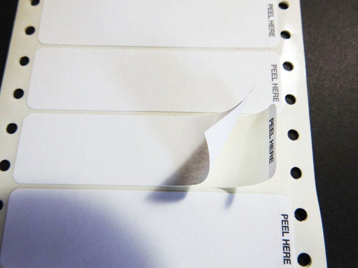Pinfed Piggyback Labels with Peel Here Designation